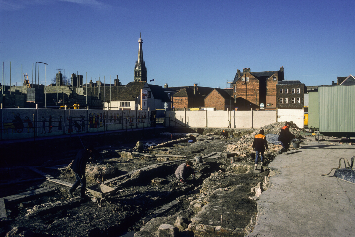 The site during excavation with Salisbury Cathedral visible behind