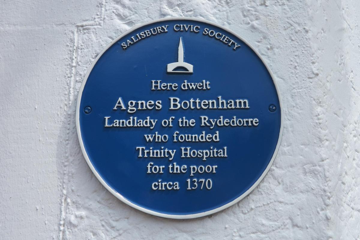 A plaque reading 'Here dwelt Agnes Bottenham, Landlady of the Rydedorre, who founded Trinity Hospital...'
