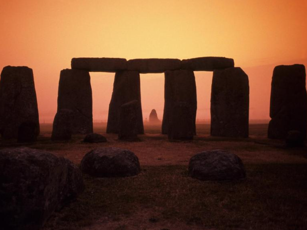 A photograph of stonehenge at sunset.