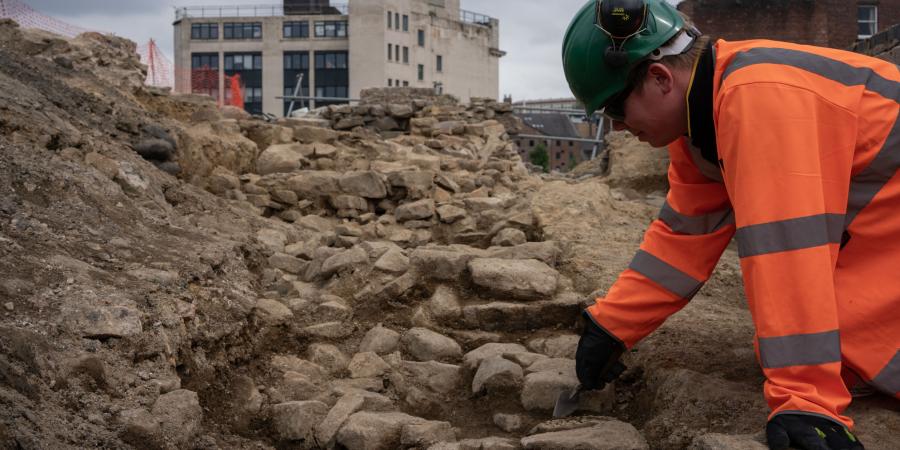 Archaeologist, Owen, excavates newly discovered castle walls