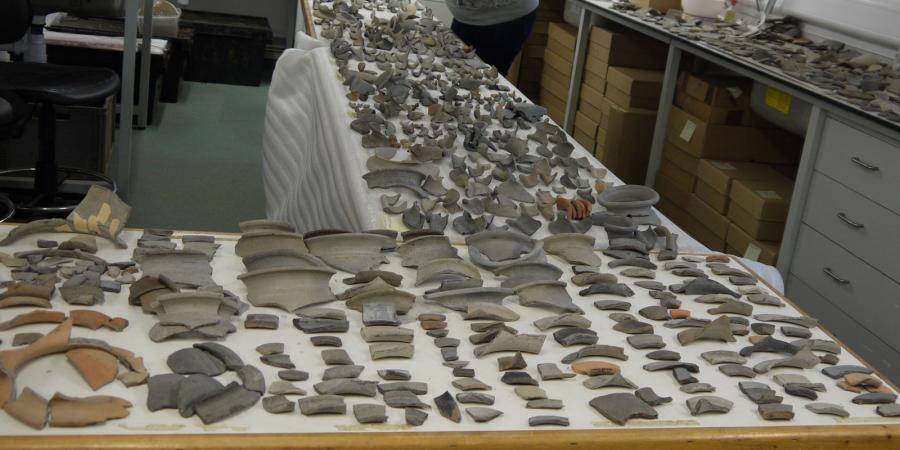 A table covered in pottery sherds from the SSSM kiln site