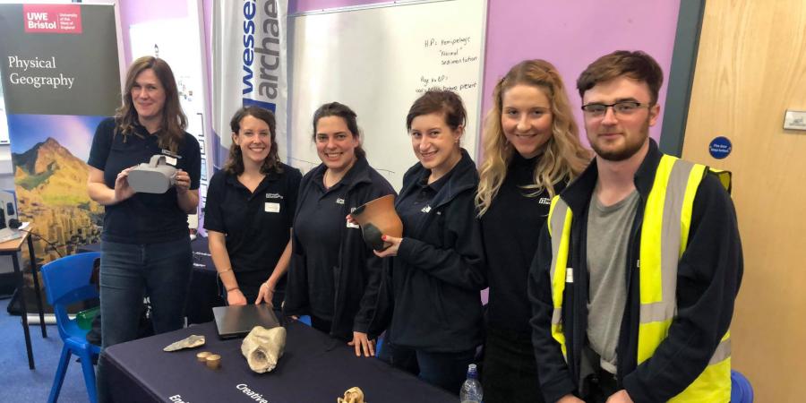 Wessex Archaeology STEM ambassadors stand together behind table at British Science Week