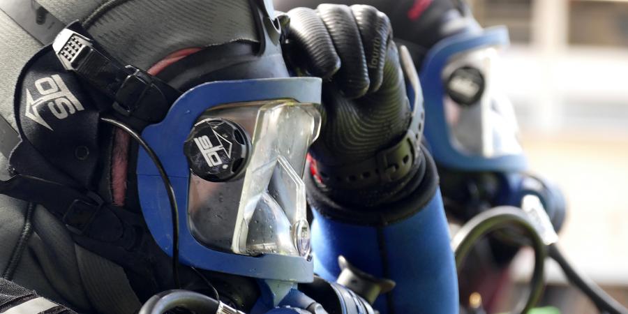 Side profile of a diver's head wearing a face mask, before diving.