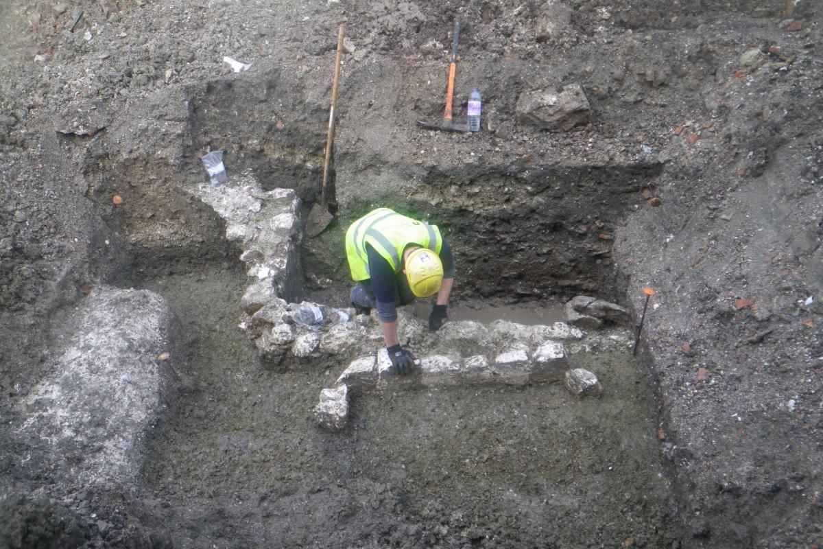 Archaeologist excavating trench at 7-11 Brown Street