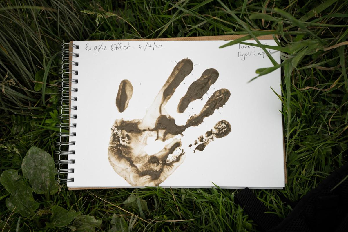 A hand print created using mud in one of the participant's sketchbooks 