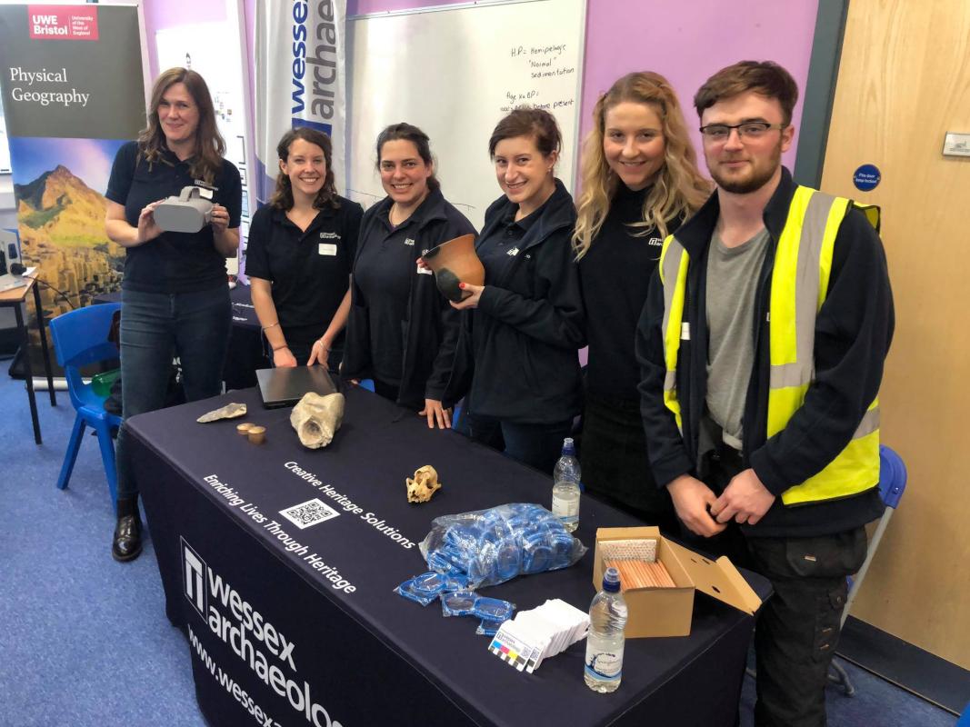 Wessex Archaeology STEM ambassadors stand together behind table