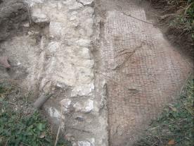 Floor and wall remains within a trench at Litlington